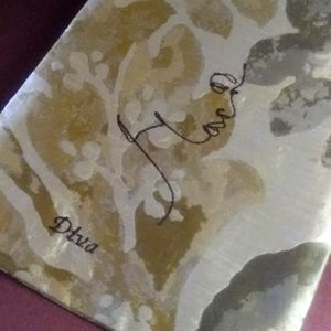 Crossbody pouch with embroidery design of a woman's face